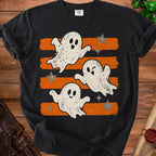 Black t-shirt with three playful ghosts and stars on orange and black stripes.