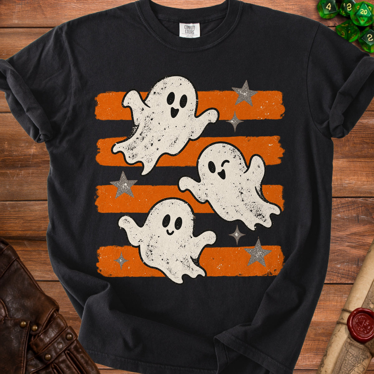 Black t-shirt with three playful ghosts and stars on orange and black stripes.