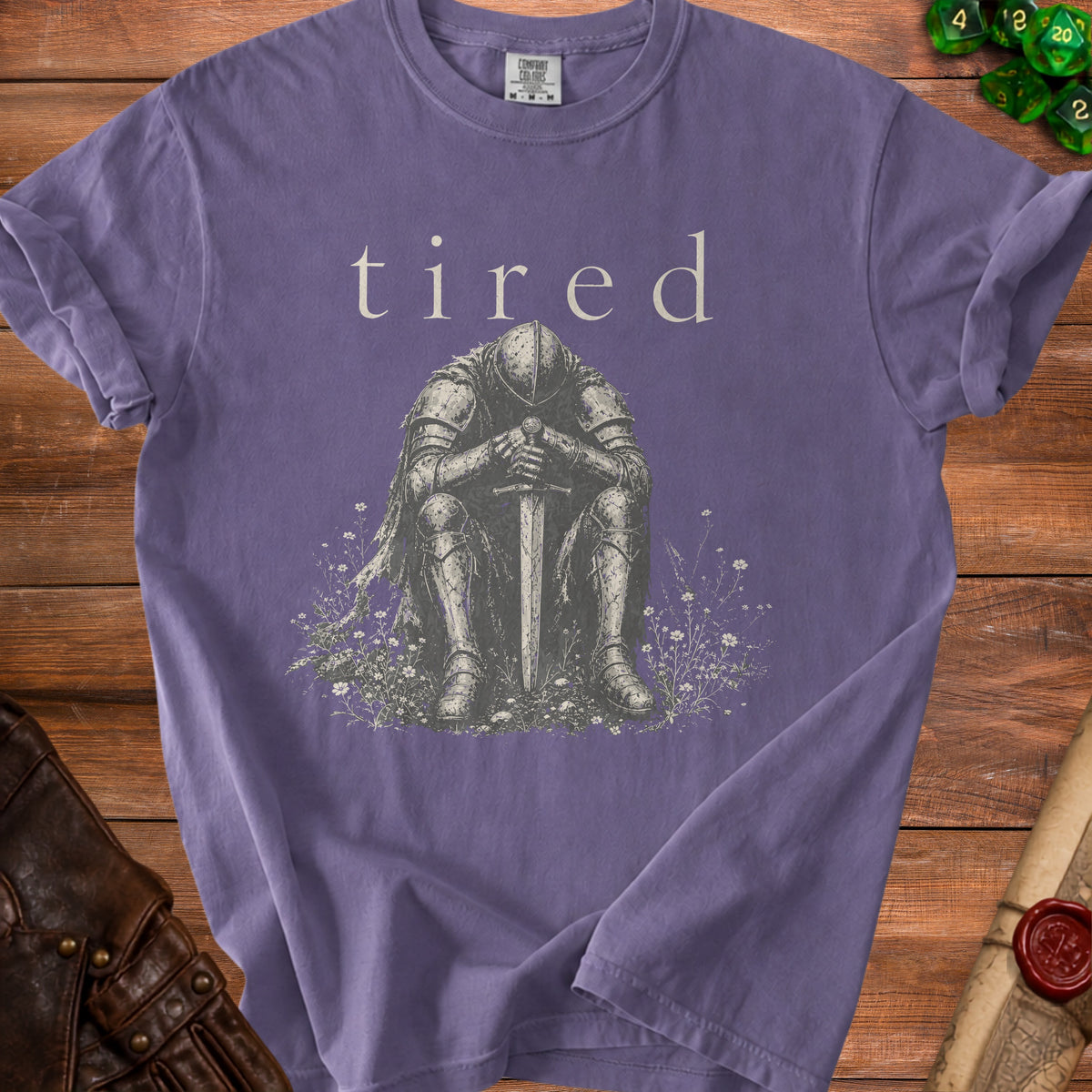 T-shirt with "tired" text above knight sitting with sword.
