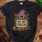 A black t-shirt features a graphic of a creature in a tree stump wearing a witch hat and holding a sign that says DO NOT PERCEIVE.