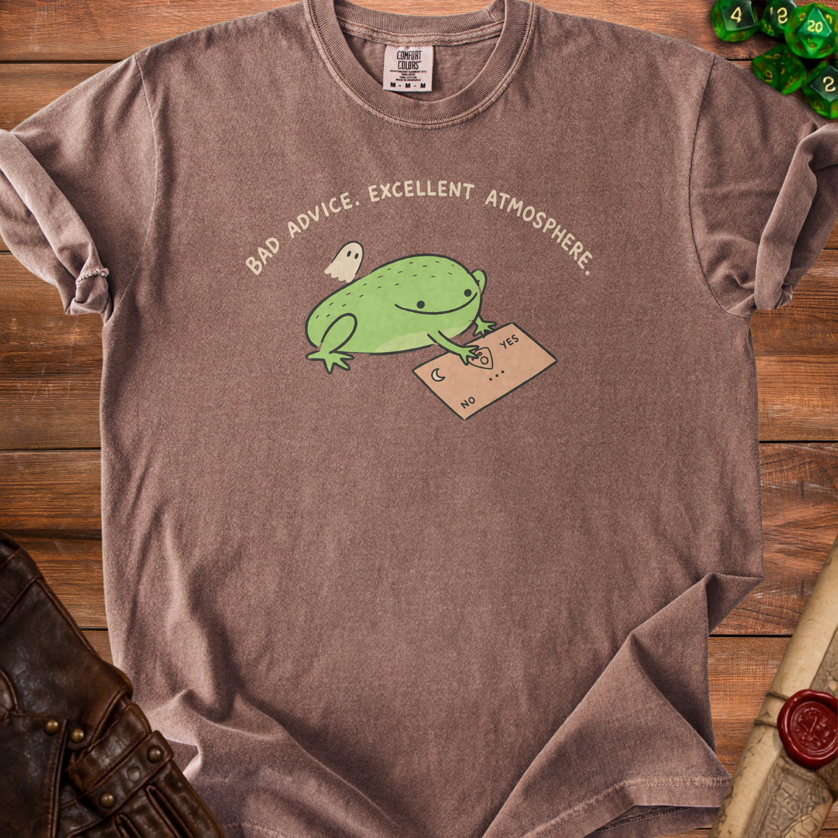 Brown t-shirt with a frog, ghost, and ouija board graphic saying "Bad Advice. Excellent Atmosphere."