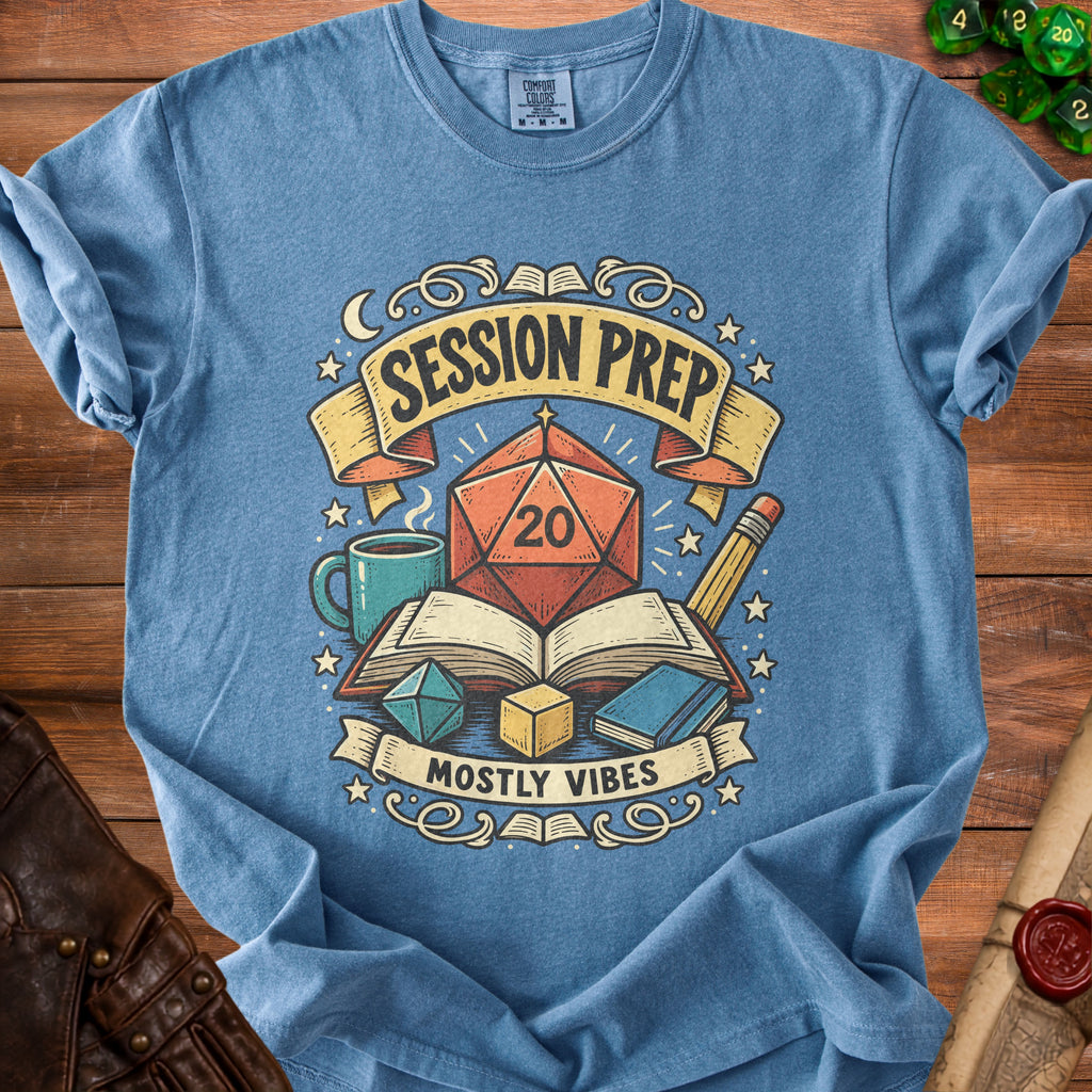 Blue t-shirt graphic with "Session Prep" and "Mostly Vibes" text, dice, book, and mug.