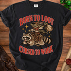 Black t-shirt with "Born to Loot Cursed to Work" text and goblin riding raccoon graphic.