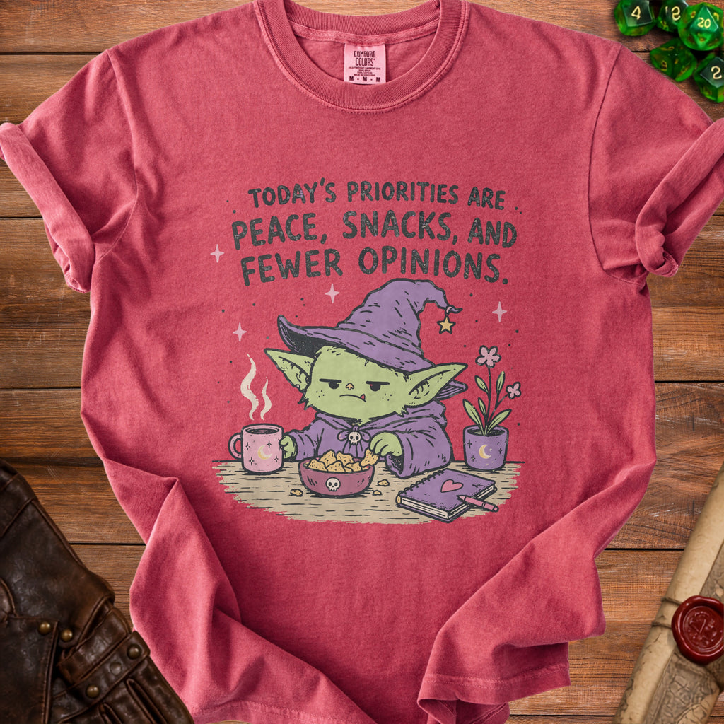T-shirt with "Today's Priorities are Peace, Snacks, and Fewer Opinions" and a goblin wizard.