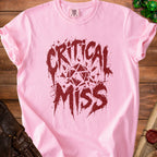 Pink t-shirt with dark red "CRITICAL MISS" text and fragmented dice graphic.