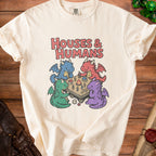 Cream t-shirt with "HOUSES & HUMANS" text and cartoon dragons playing a board game.