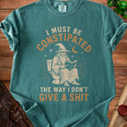 Wizard on toilet reading book with text "I MUST BE CONSTIPATED THE WAY I DON'T GIVE A SHIT"