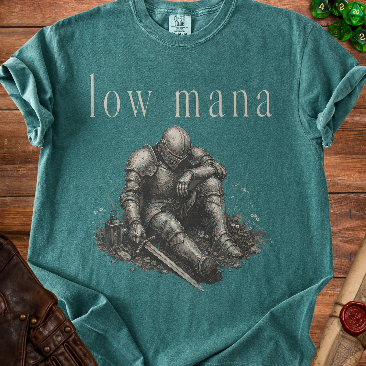 Green t-shirt with "low mana" text and illustration of a seated knight.