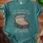 Goblin sleeping in a coffin on a t-shirt with text: "Let me just slip into something cozy, like a coma or something."