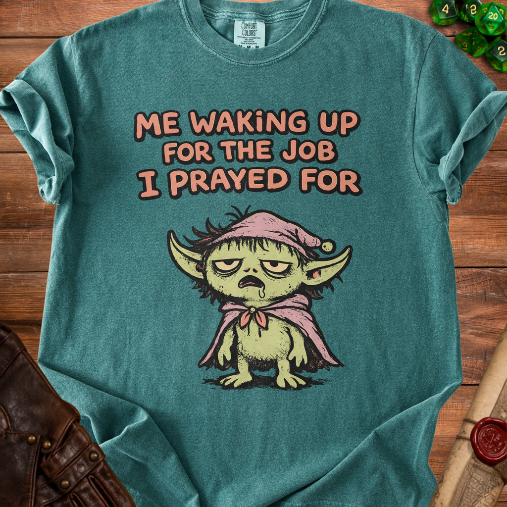 Teal t-shirt with cartoon creature and text "Me Waking Up For the Job I Prayed For".