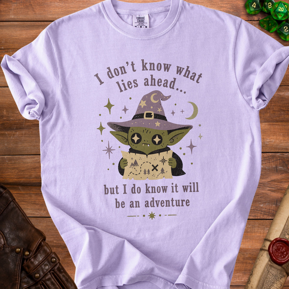Purple t-shirt with graphic of a goblin wizard holding a treasure map and text.