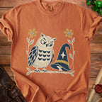 T-shirt with owl, mouse, witch hat, and flowers graphic.