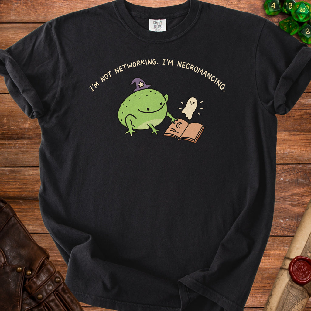 Black t-shirt with a cartoon frog in a witch hat, a ghost, and an open book.