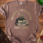 Brown t-shirt with a black cat wearing a witch hat on books, text "NO SPELLS, NO PROBLE" and "ONLY VIBES".