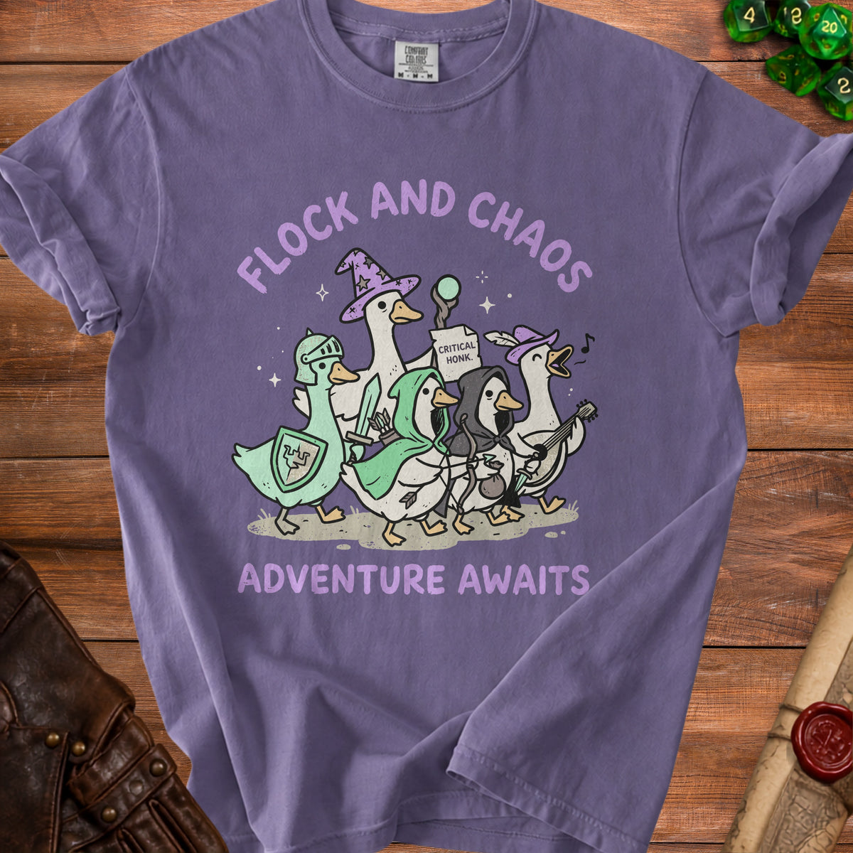 Purple t-shirt with ducks in fantasy armor and costumes, text "FLOCK AND CHAOS ADVENTURE AWAITS".
