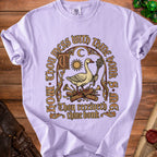 Light purple t-shirt with graphic of goose holding mace, sun, moon, and text.