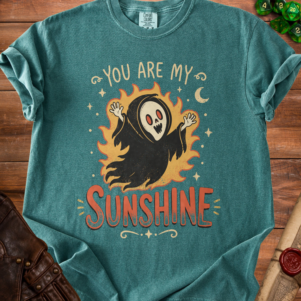 Grim reaper graphic with text "You Are My Sunshine" on a teal t-shirt.