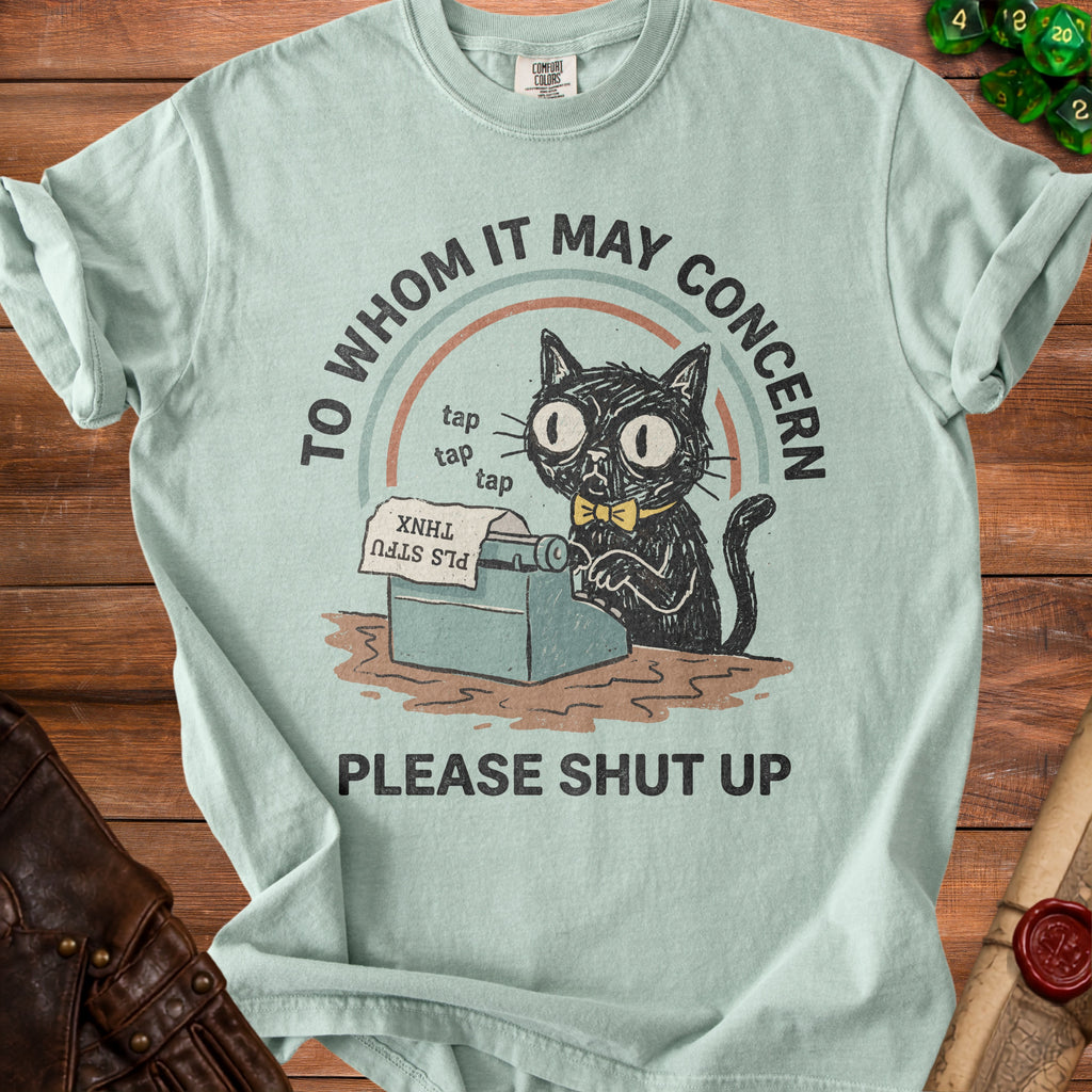 Black cat with glasses at a typewriter, "To Whom It May Concern Please Shut Up".