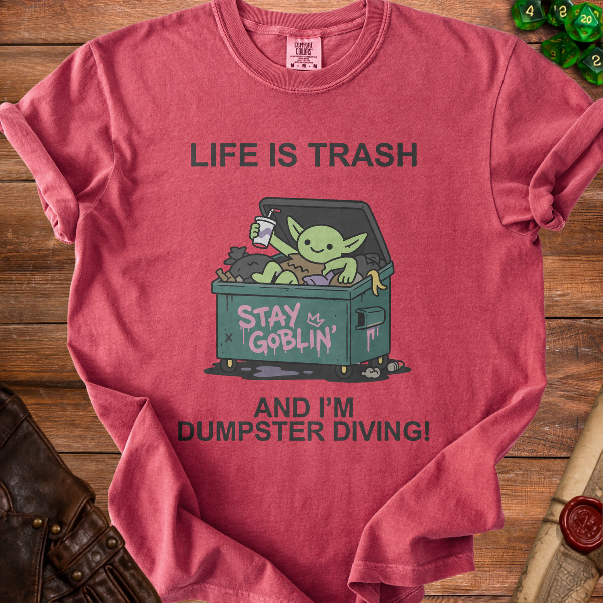 Red t-shirt with green goblin in dumpster saying "Life is trash, stay goblin, and I'm dumpster diving!"