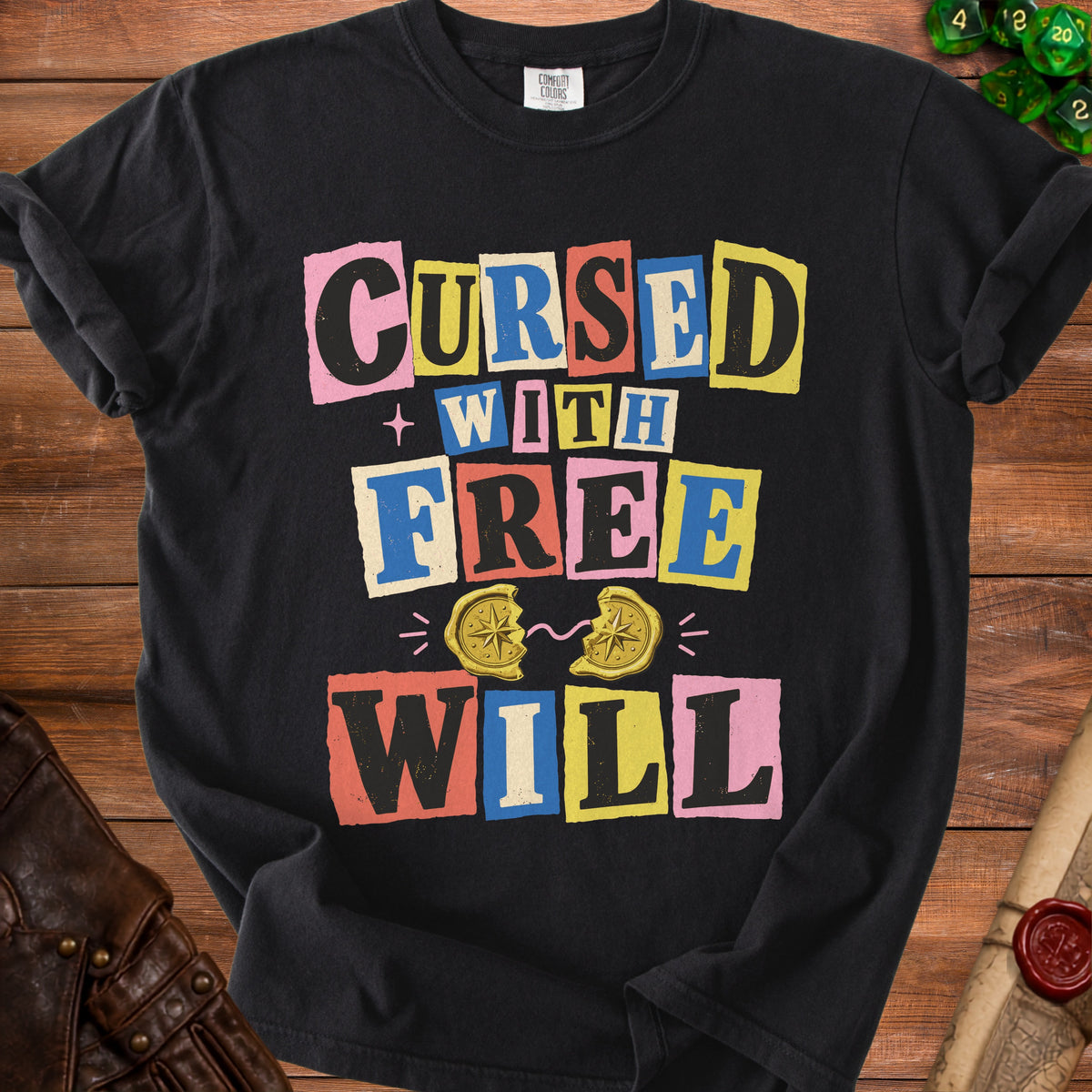 Black t-shirt with text "CURSED WITH FREE WILL" and broken compass graphic.