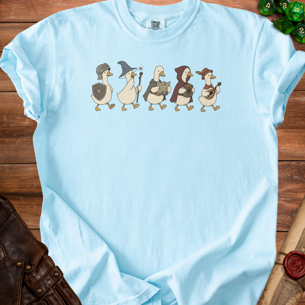 Light blue t-shirt with cartoon ducks dressed as fantasy adventurers.