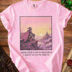 Pink t-shirt with knight looking at castle, reads "Looking hotter in your 30s than in your 20s".