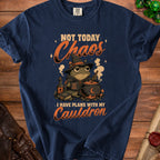 T-shirt with a witchy frog, cauldron, and the text "Not Today Chaos, I Have Plans With My Cauldron."