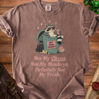 T-shirt with raccoon in trash can, "Not Your Problem" text, and "Not My Circus" quote.