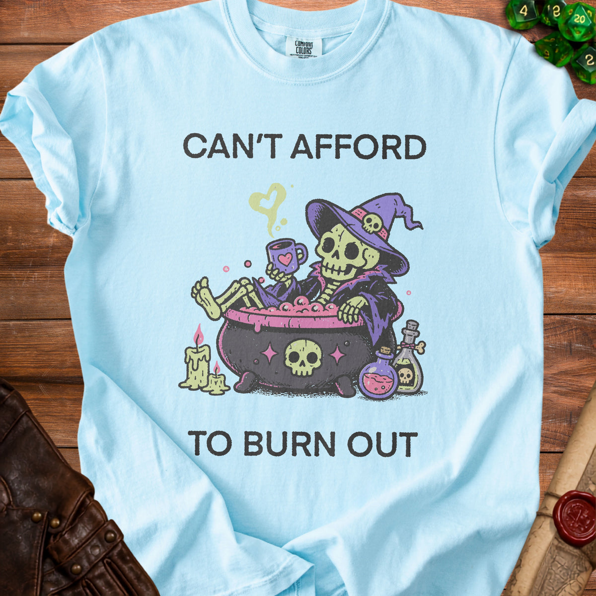 Skeleton in witch hat and cauldron with text "CAN'T AFFORD TO BURN OUT".