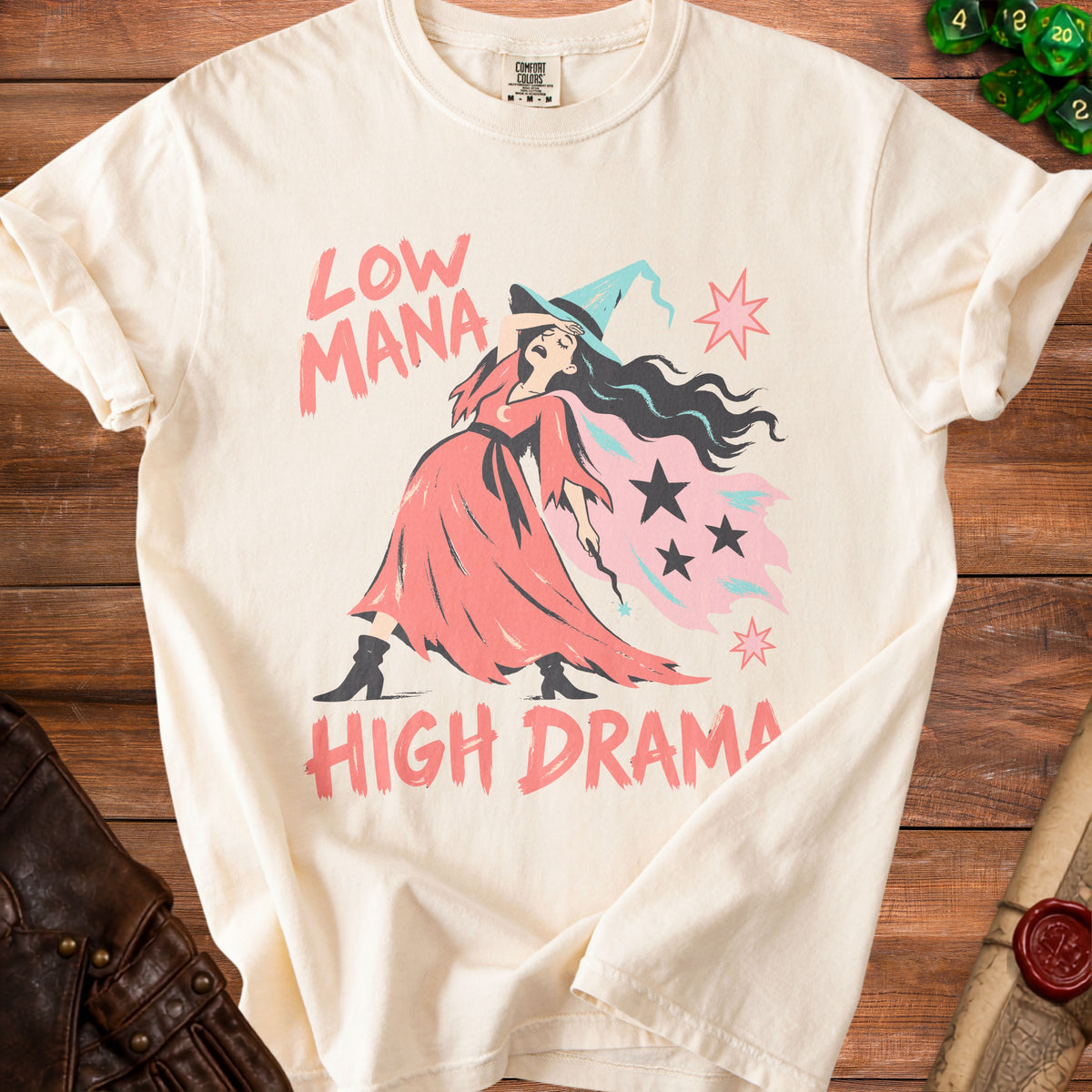 Cream t-shirt with distressed graphic of a witch and text "LOW MANA HIGH DRAMA."