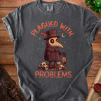 Dark grey t-shirt with plague doctor illustration and text "PLAGUED WITH PROBLEMS."