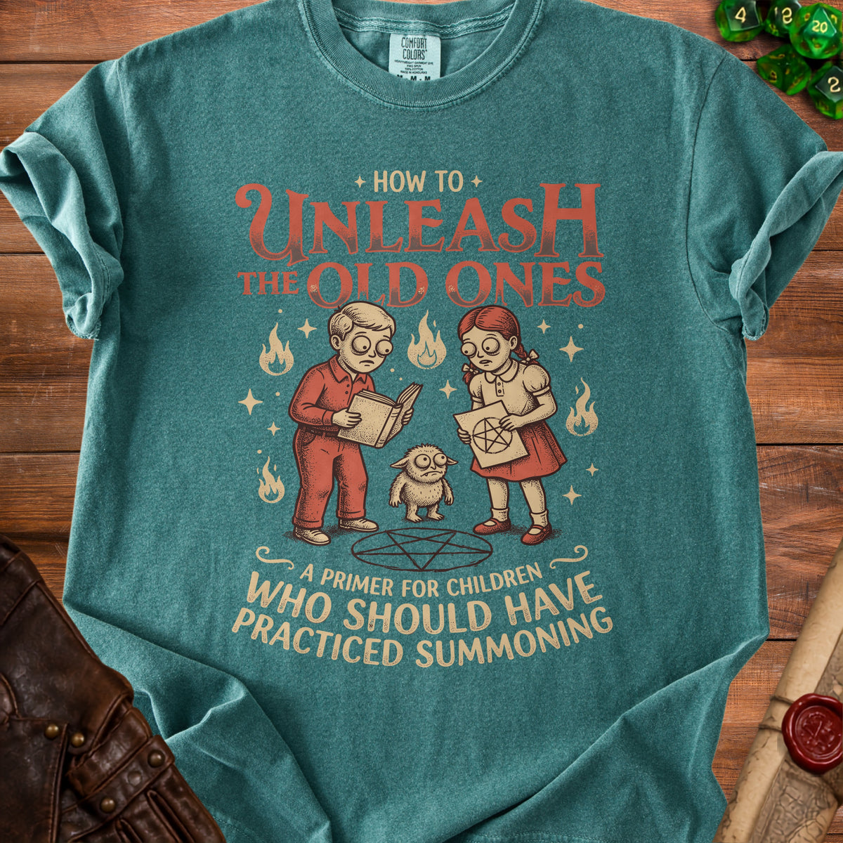 Teal t-shirt with "How to Unleash the Old Ones: A Primer for Children Who Should Have Practiced Summoning" text.