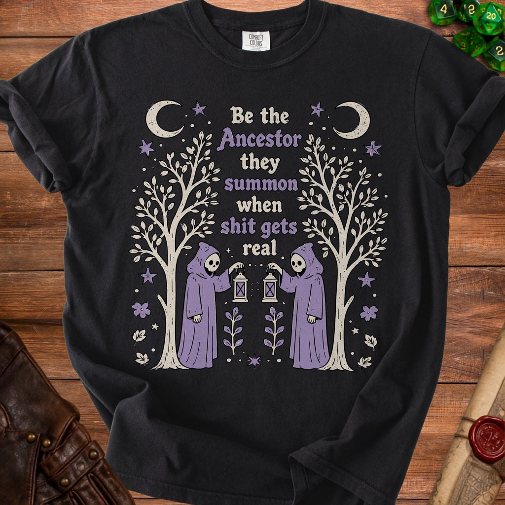 Black t-shirt with "Be the Ancestor they summon when shit gets real" graphic.