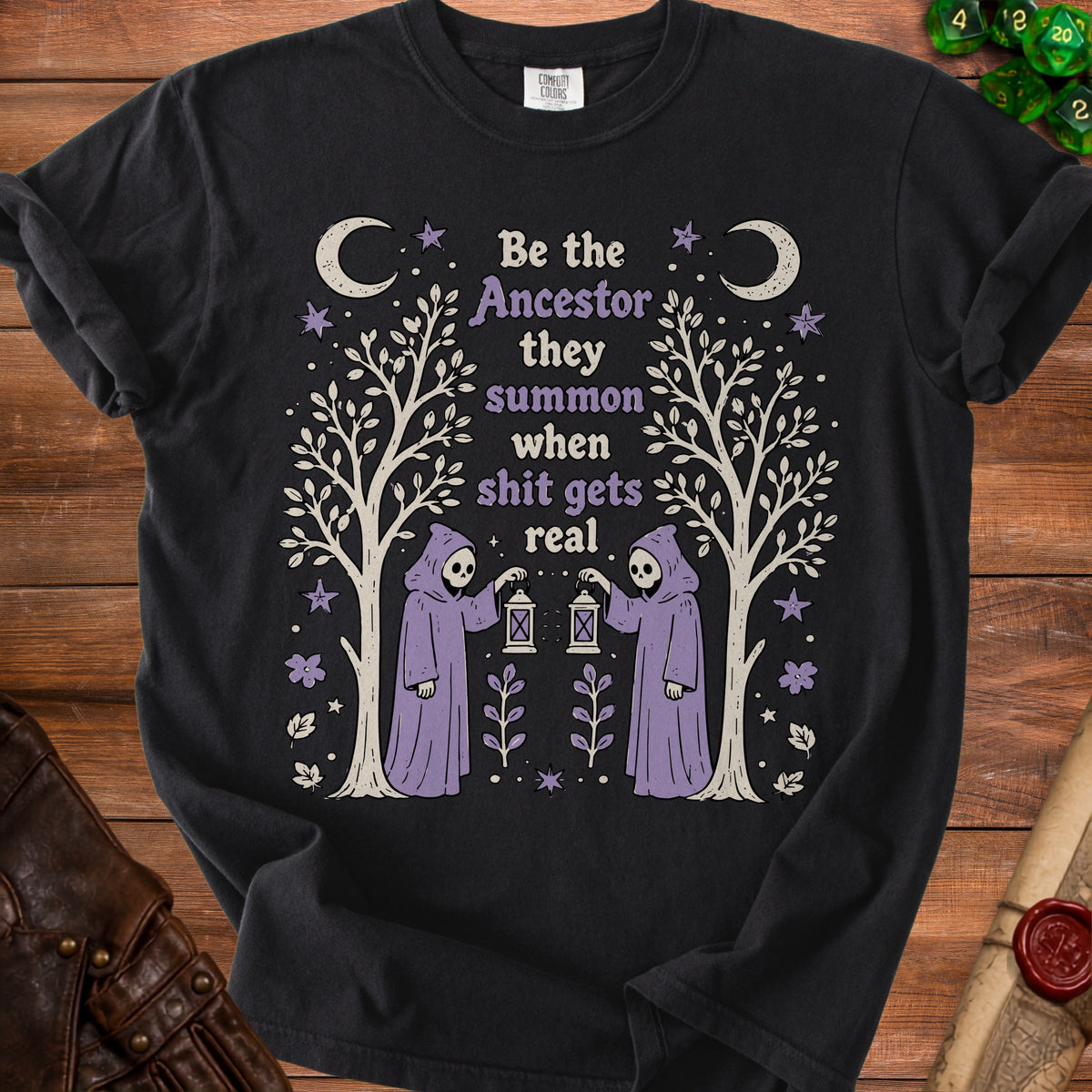 Black t-shirt with "Be the Ancestor they summon when shit gets real" graphic.