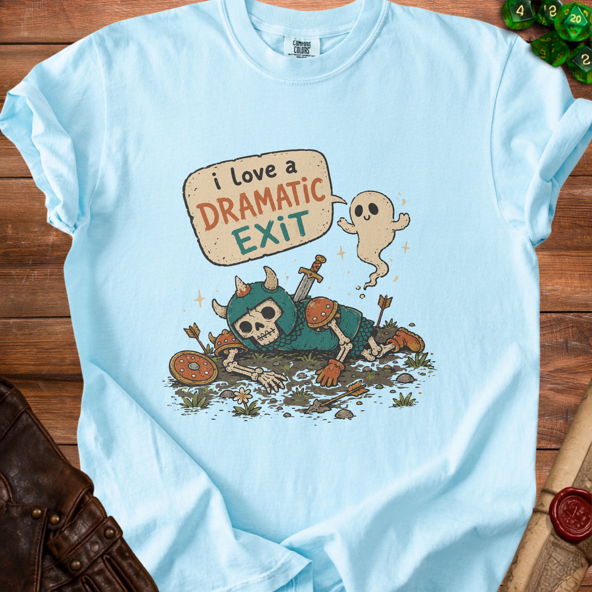Light blue Comfort Colors t-shirt with a skeleton warrior and ghost graphic saying "I love a dramatic exit".
