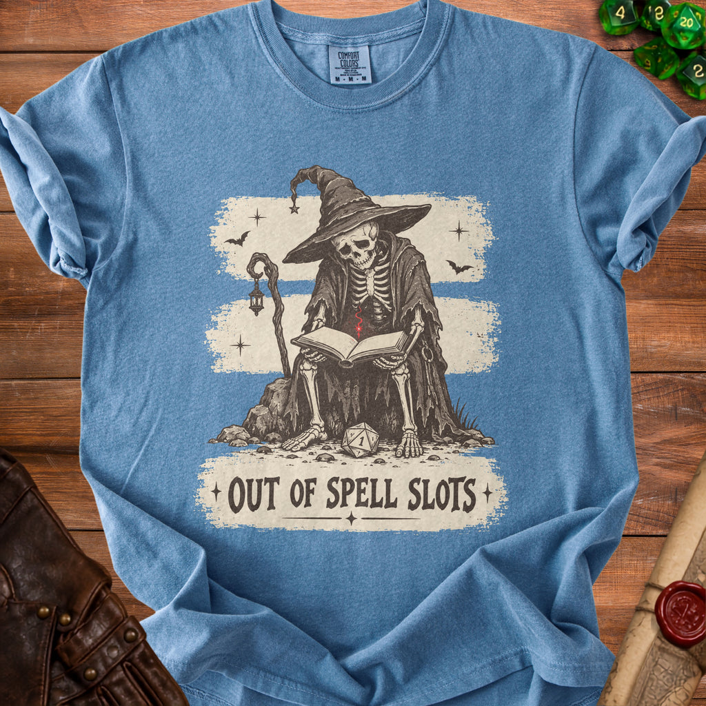 Blue t-shirt with skeleton wizard reading a book, "Out of Spell Slots" text.