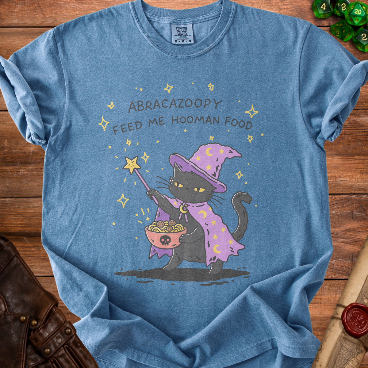 Blue t-shirt with black cat wizard holding a bowl of spaghetti and meatballs.