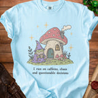 Light blue t-shirt with wizard frog by mushroom house, "I run on caffeine, chaos and questionable decisions."