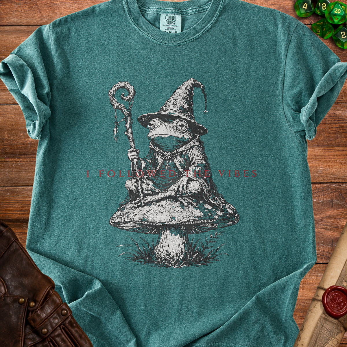 T-shirt with wizard frog on mushroom, text says "I FOLLOWED THE VIBES."