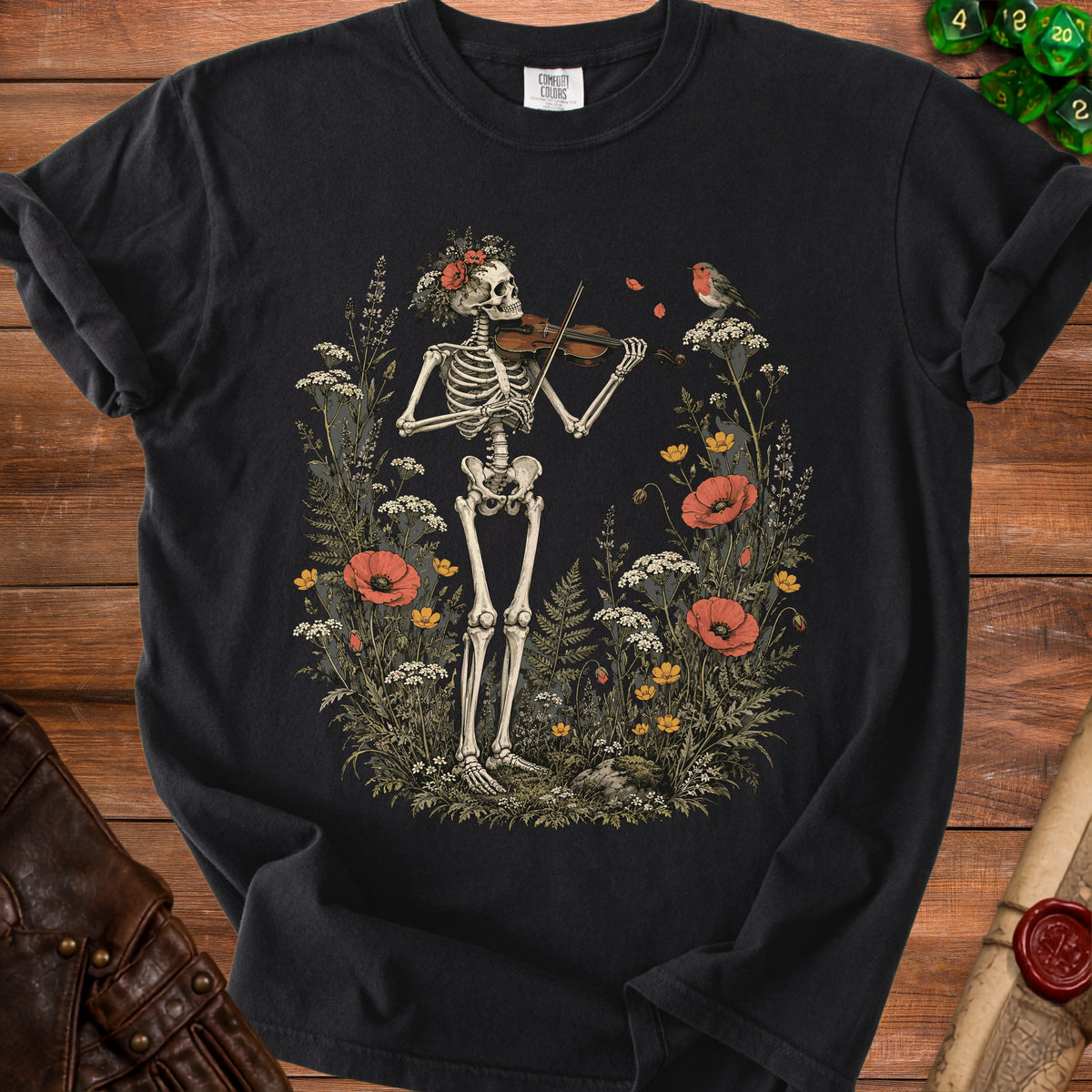 Skeleton playing violin among flowers with a robin on a black Comfort Colors t-shirt.