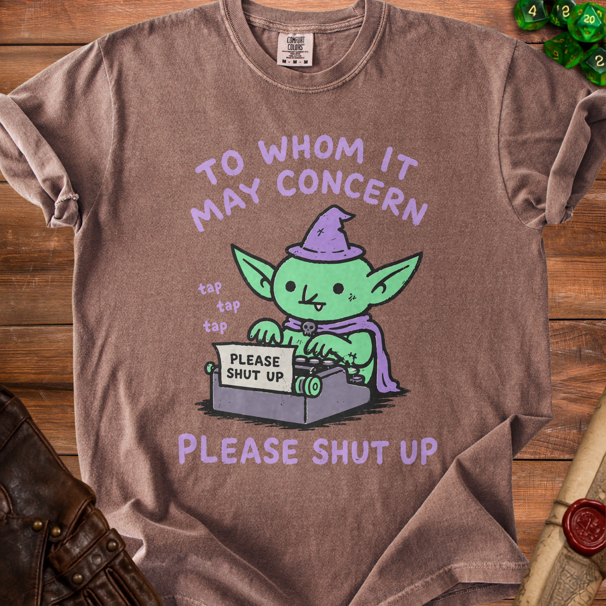 Brown t-shirt with a green goblin at a typewriter saying "PLEASE SHUT UP".