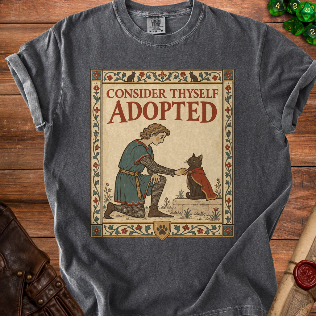 T-shirt graphic of a knight kneeling before a cat with text "CONSIDER THYSELF ADOPTED."