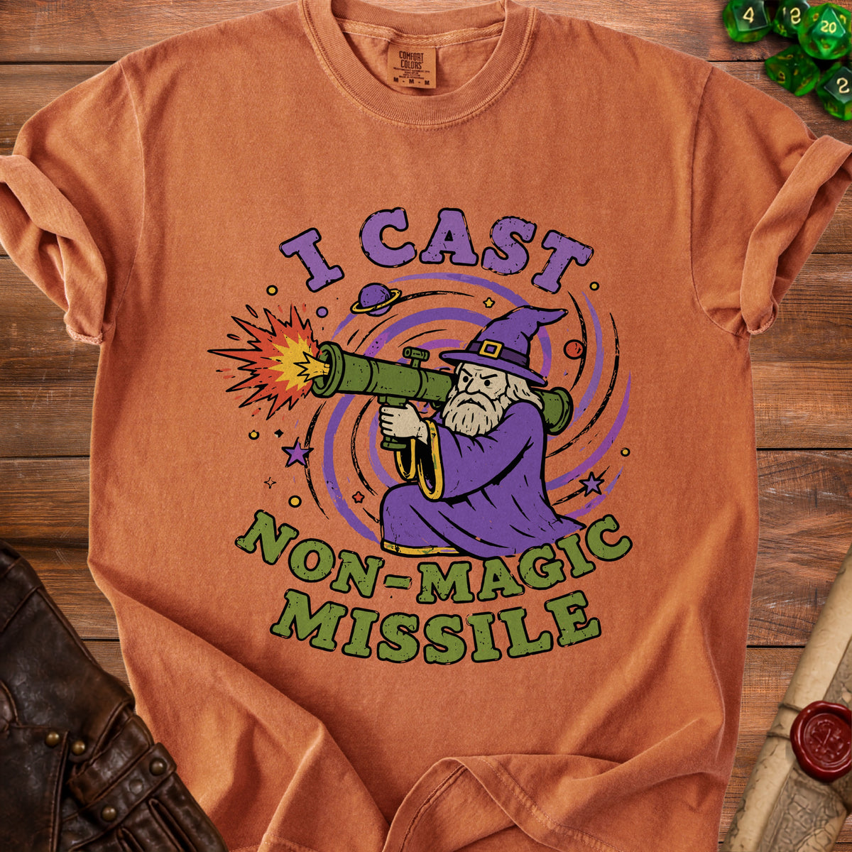 Orange t-shirt with wizard firing a rocket launcher, text "I CAST NON-MAGIC MISSILE".
