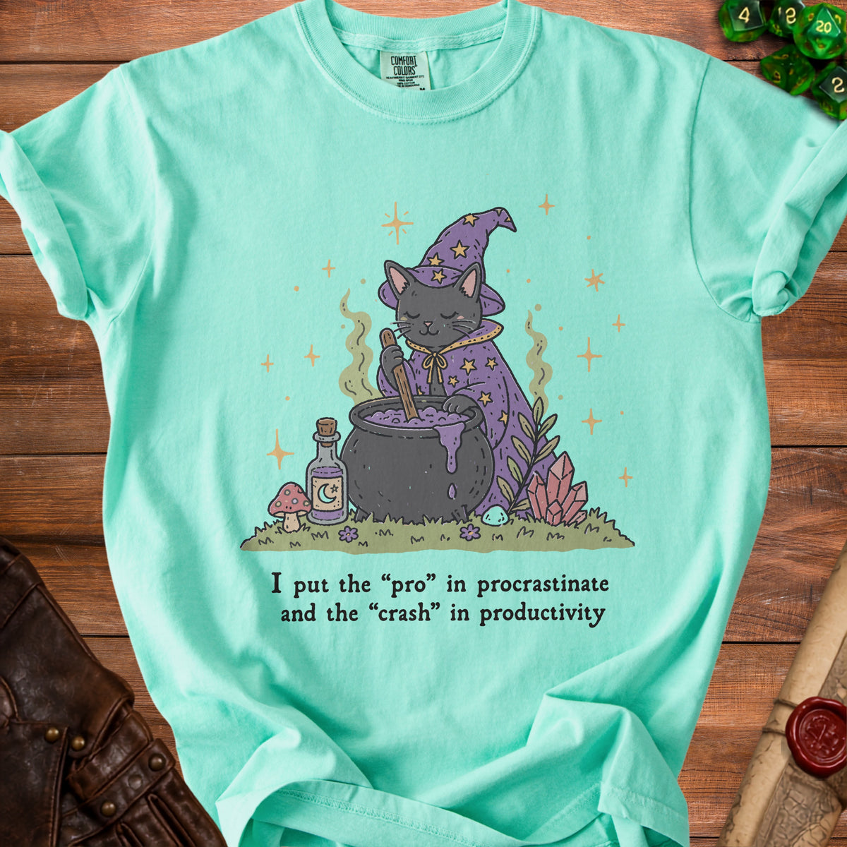 Mint green t-shirt with a wizard cat stirring a cauldron and text "I put the 'pro' in procrastinate and the 'crash' in productivity".