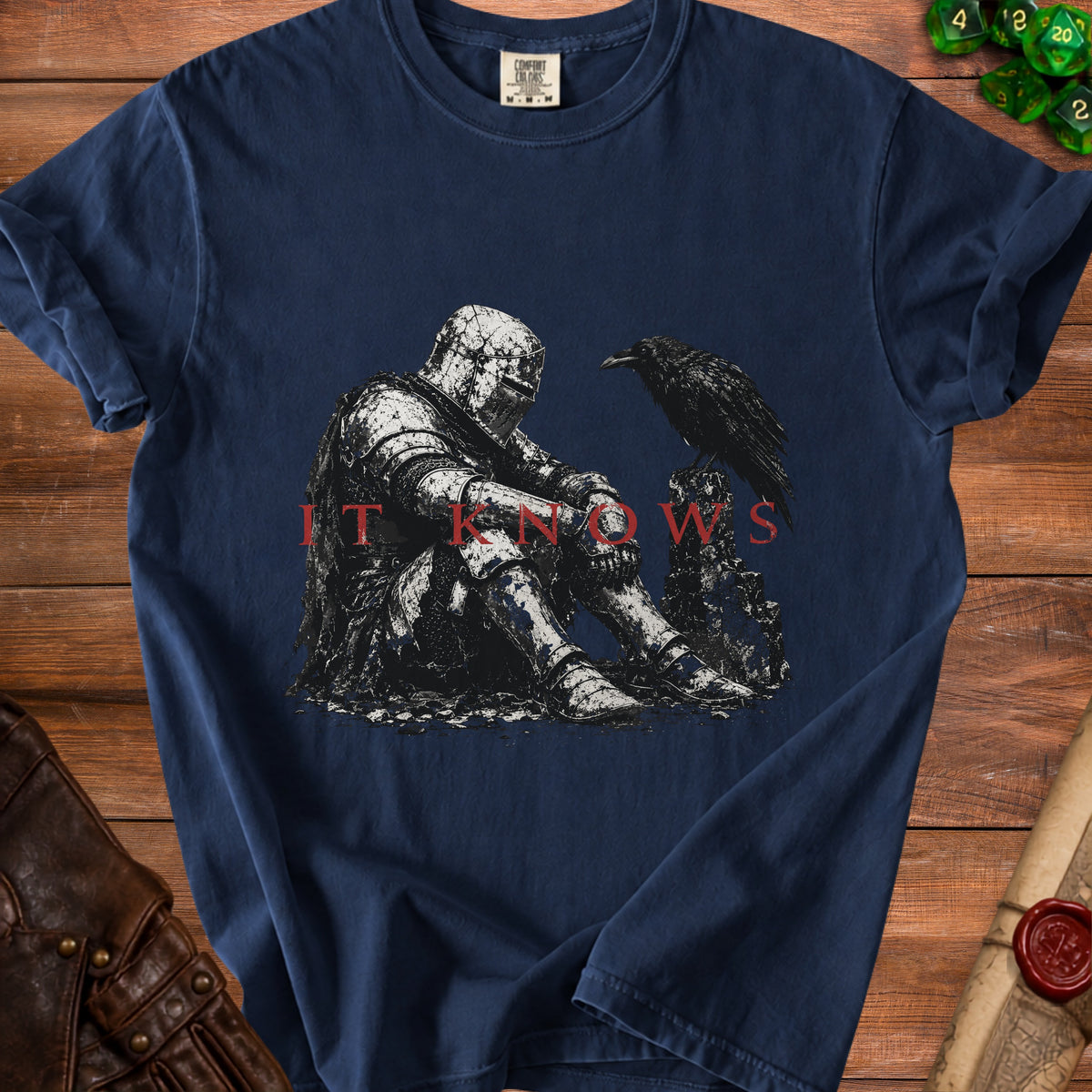 Dark blue t-shirt with a knight and raven graphic and "IT KNOWS" text.