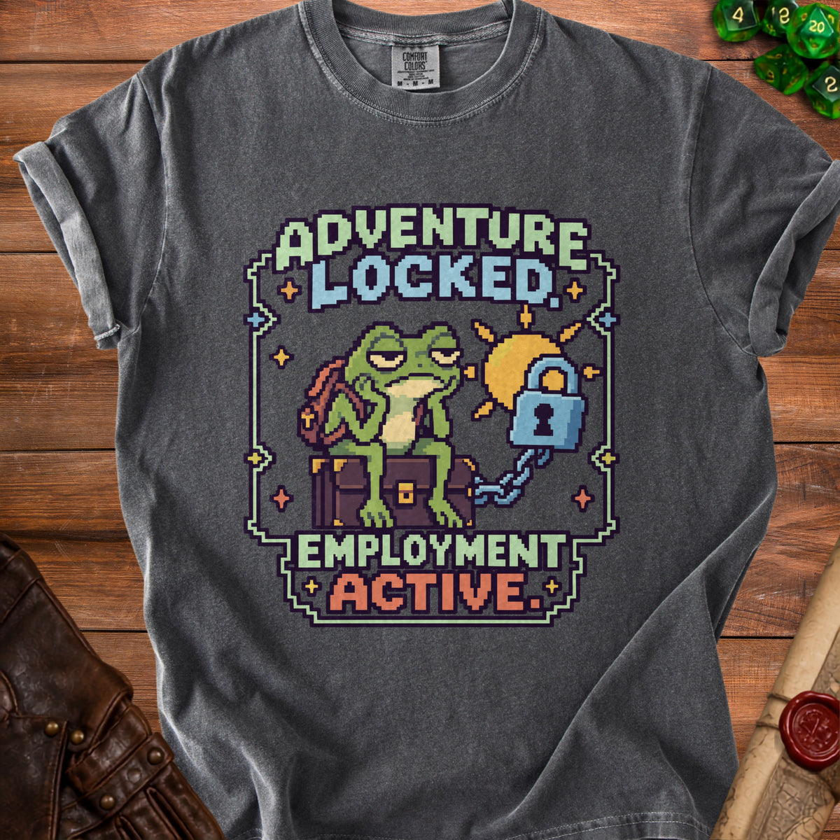 Charcoal t-shirt featuring pixel art of a tired frog sitting on a chest next to the text Adventure Locked Employment Active.