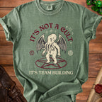 Green t-shirt with Cthulhu illustration and text "IT'S NOT A CULT IT'S TEAM BUILDING".