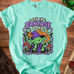 Green goblin wearing witch hat and cape with text "Off in Fantasy Land".