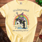 Yellow t-shirt with "undiagnosed but something ain't right" text and wizard riding an orca over a rainbow.