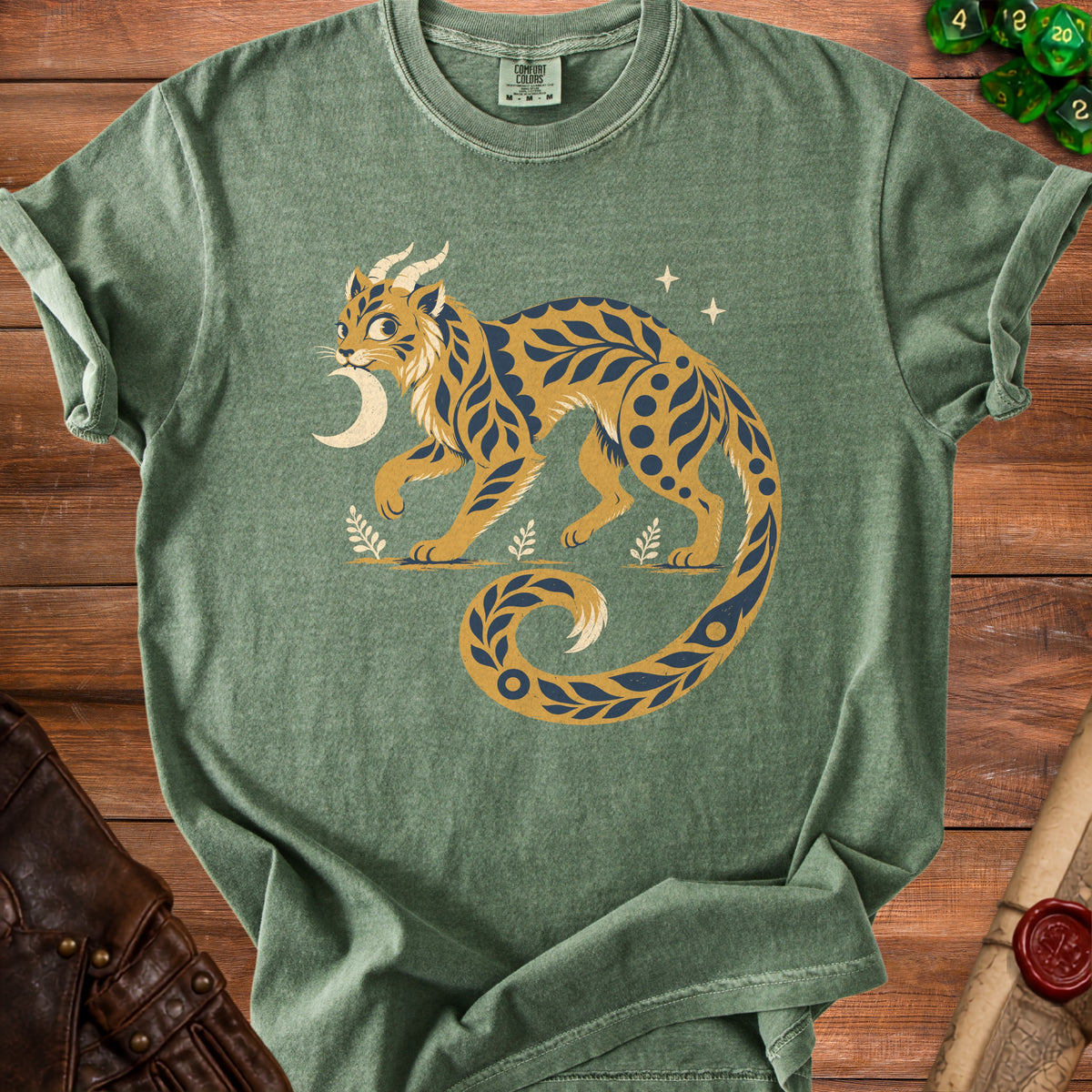 Green t-shirt with mystical cat design, crescent moon, and stars.